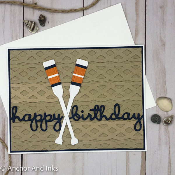 birthday greeting card with a woven cord-like dimensional background, two striped, dimensional crossed oars with a woodgrain pattern as well as the dimensional die cut words "happy birthday"