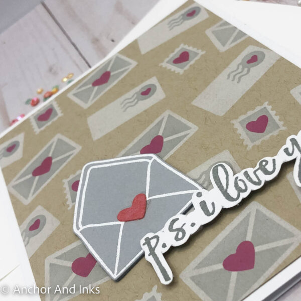 Stenciled envelopes and stamps are the backdrop to this love letter related Valentine card.