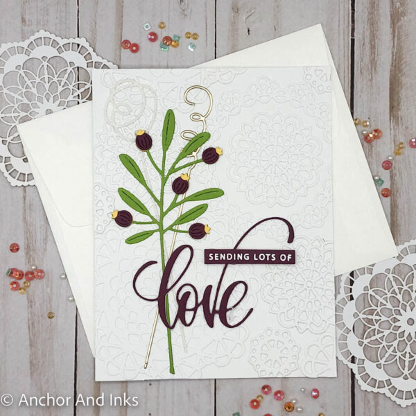 Traditional valentine with a twist - white die cut doily background, flowers, a little sparkle and shine of glitter and gold and a profession of love.